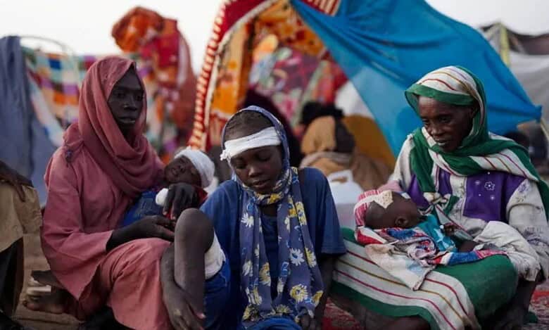 Displaced Sudanese families, including injured children, rest at a camp in Tawila, North Darfur, after fleeing El-Fasher..