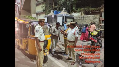 An auto driver is made to blow in a breathalyser during a drunk driving check in Hyderabad