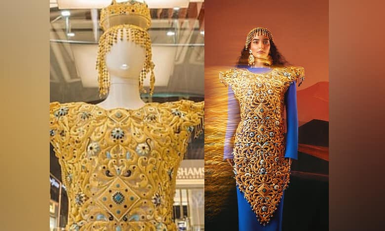 The “Dubai Dress,” crafted by Al Romaizan Gold and Jewellery, an intricately engraved 21-karat gold gown adorned with gemstones and a matching headdress.