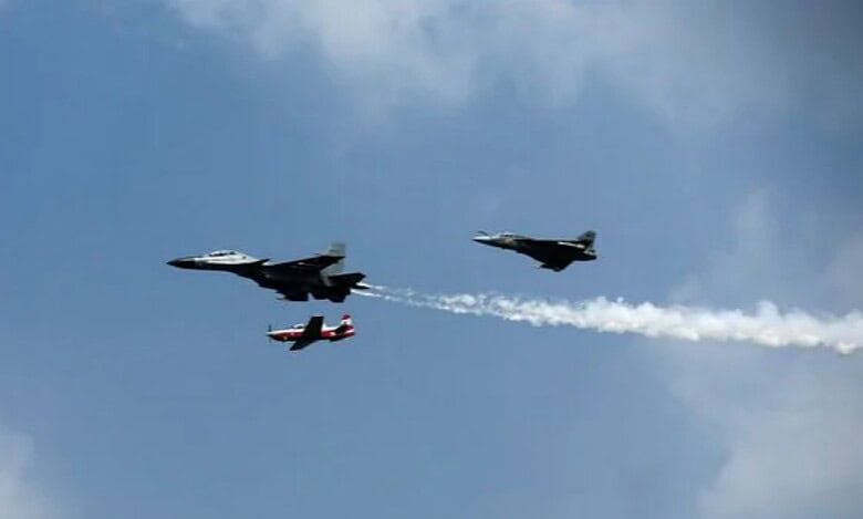 Indian Air Force fighter jets performing in formation during a flight demonstration.