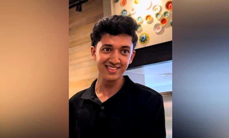 Vaishnav Krishnakumar, an 18-year-old Indian student in Dubai, smiling in a casual indoor setting.