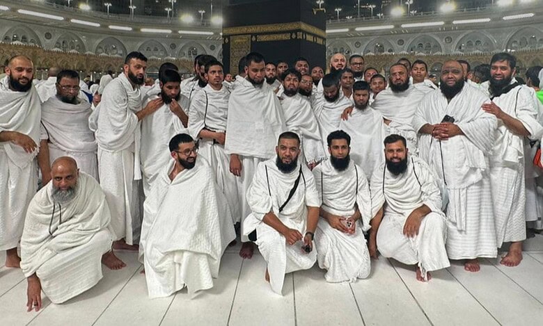 A group of Indian pilgrims with sensory disabilities dressed in ihram pose for a photo after completing Umrah at the Grand Mosque in Makkah.