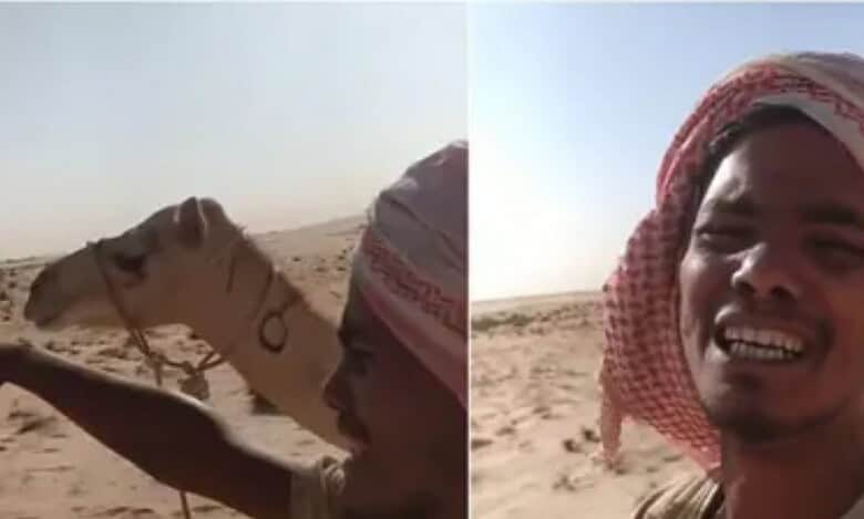 Indian man appears in a desert with a camel in the background while recording a video plea for help.