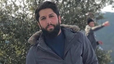 Issa Ahmad Karbala, Hezbollah Radwan Force platoon commander, poses outdoors on a snowy day.