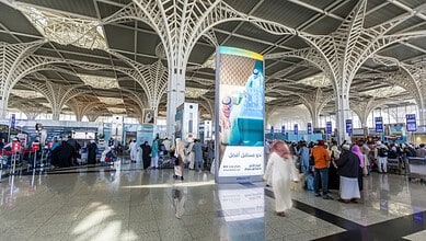 Interior view of Prince Mohammad bin Abdulaziz International Airport in Madinah showing passengers at the departure hall.