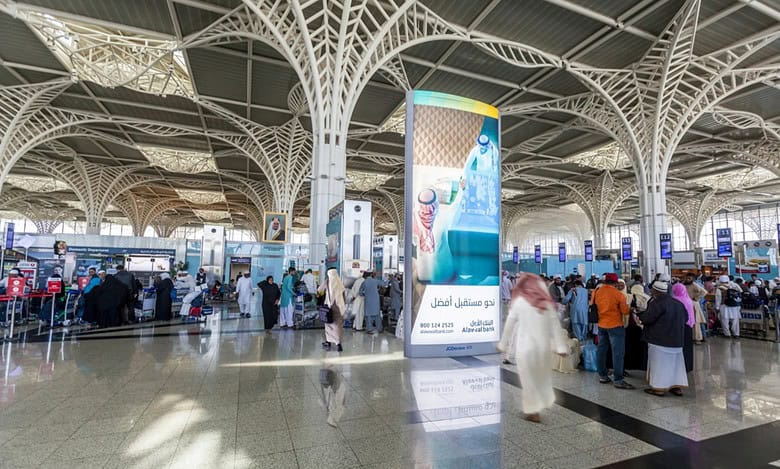 Interior view of Prince Mohammad bin Abdulaziz International Airport in Madinah showing passengers at the departure hall.