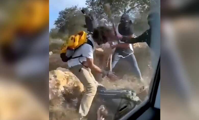 Masked settlers assault Palestinian farmers and activists during the olive harvest in Turmus Ayya, West Bank, October 19.