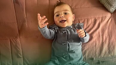 Palestinian baby Mira Suhaib Akkad smiling after successful heart surgery in Saudi Arabia.