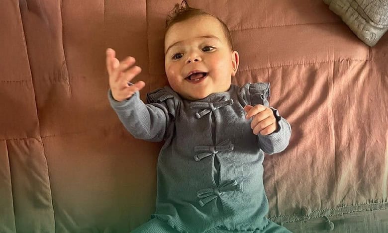Palestinian baby Mira Suhaib Akkad smiling after successful heart surgery in Saudi Arabia.