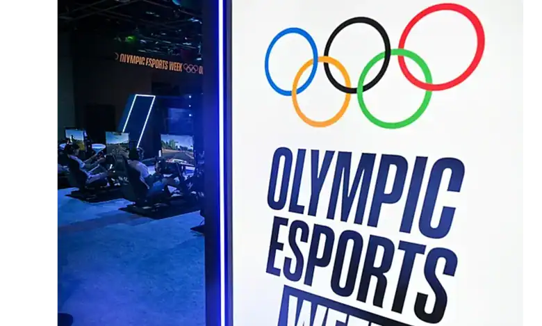 Olympic Esports Week logo displayed beside gaming stations at an event.