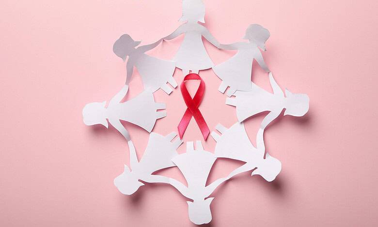 paper women and pink rbbon for cancer awareness