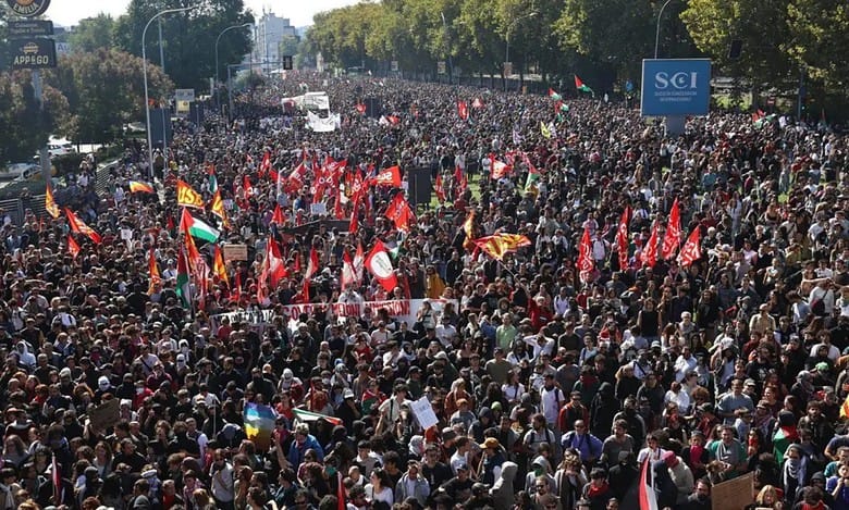 Large crowd waves flags during a pro-Palestinian protest in Bologna, Italy.