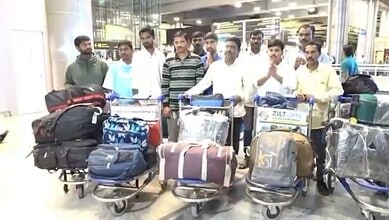Twelve Telangana migrant workers stranded in Jordan arrive safely at Hyderabad airport with their luggage after repatriation.