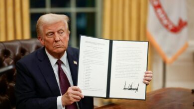 US President Donald Trump displays a signed executive order at the White House.