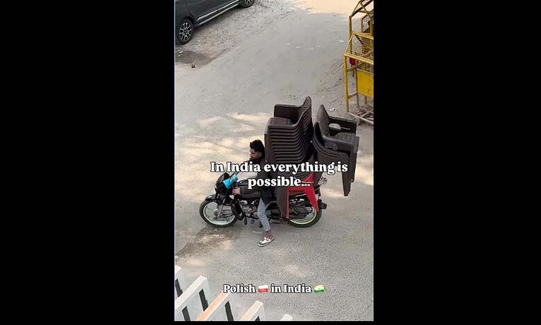 Man carries chairs on bike in India
