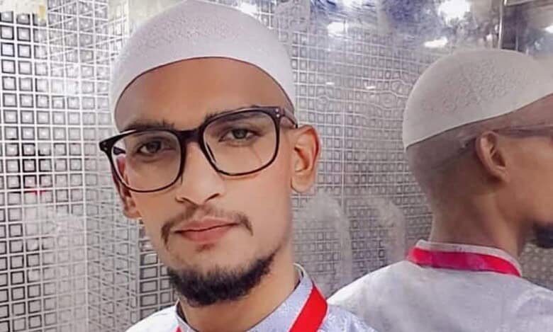 Mohammed Abdul Shoeb wearing glasses and a white prayer cap.