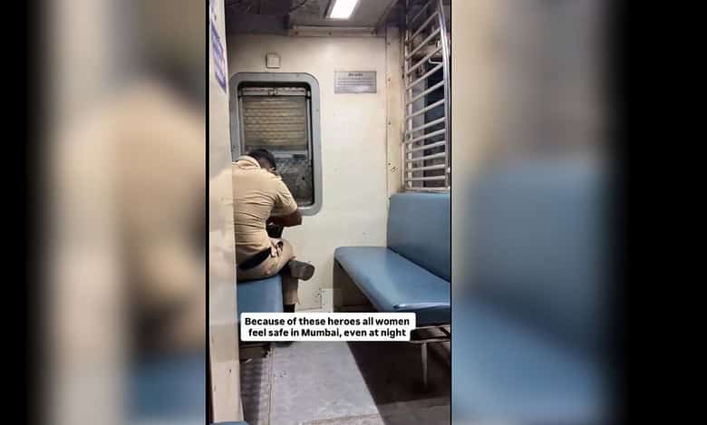 Mumbai policeman keeps watch over a lone woman on a local train.