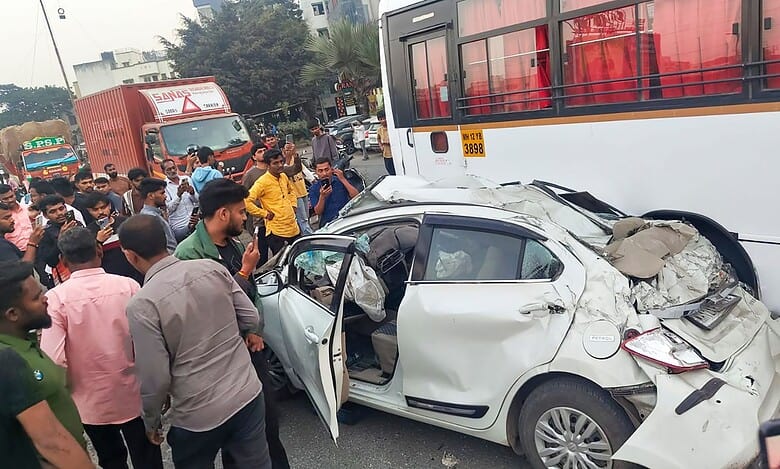 People stand near mangled remains of a car after an accident on the Mumbai-Bengaluru Highway, in Pune- PTI