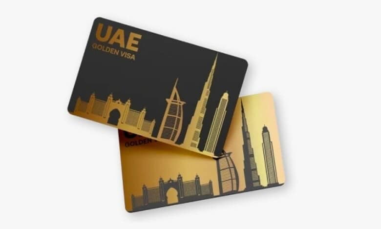 Illustration of UAE Golden Visa cards featuring gold and black designs with silhouettes of iconic Dubai landmarks, including Burj Khalifa and Burj Al Arab.