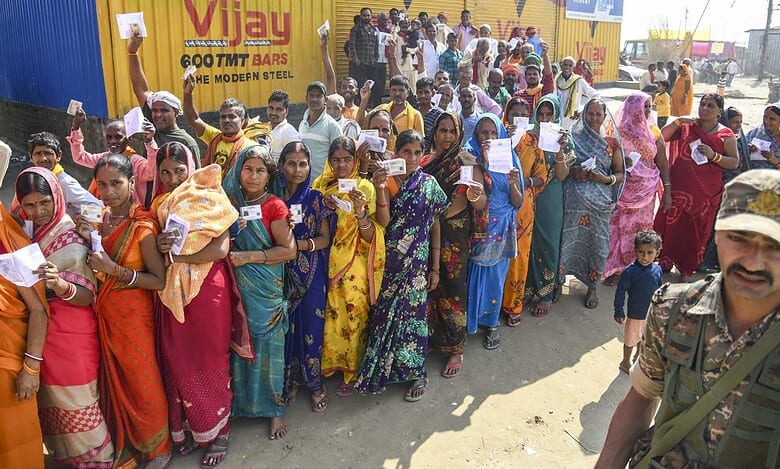 Voters wait in a queue to cast votes at a polling station during the first phase of the Bihar Assembly elections at Bakhtiarpur in Patna on Thursday. (PTI Photo)