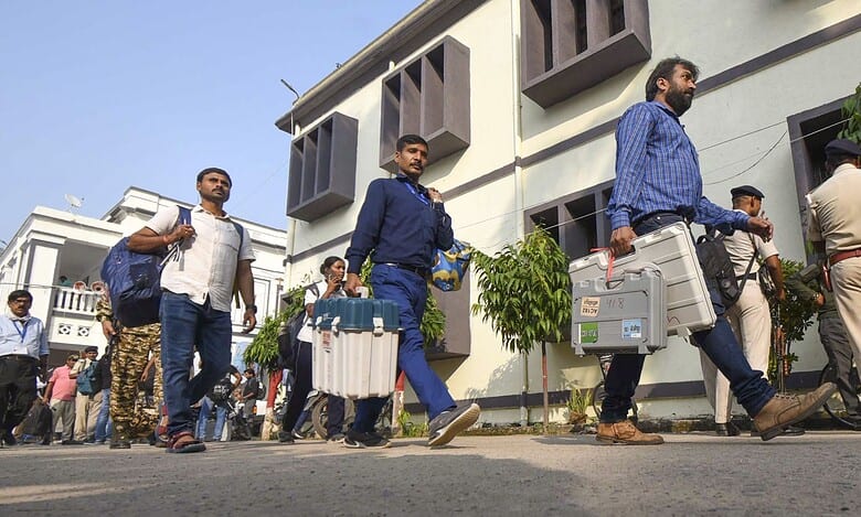 Polling officials with EVM and other election material leave for their respective booths on the eve of the first phase of the Bihar Assembly elections, in Patna on Wednesday (PTI)