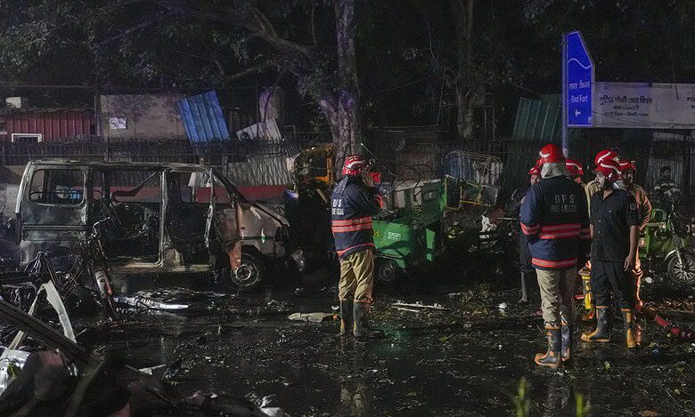Firefighters at the spot after a blast occurred in a parked car near Red Fort, leaving multiple vehicles in flames in New Delhi on Monday. At least eight people have been killed. (PTI Photo/Salman Ali)