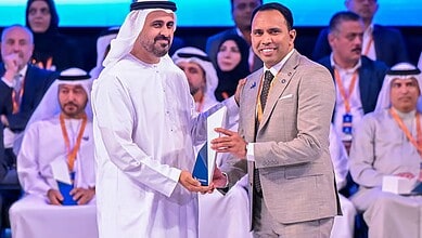 Indian expat Anas Kadiyarakam receives the labour award from Sheik Mansour bin Zayed