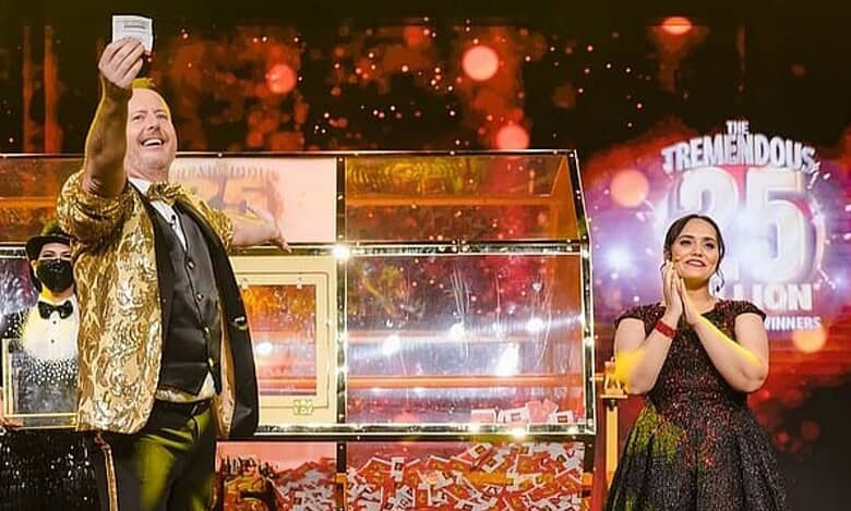 Big Ticket Abu Dhabi hosts celebrate on stage as they announce the Dh 25 million jackpot winner during a live draw, with confetti and bright lights in the background.