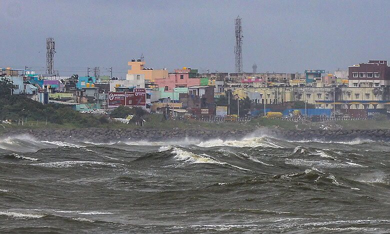 High waves lash the Kasimedu shoreline amid rough sea conditions in the wake of the Cyclone Ditwah in Chennai on Sunday. (PTI Photo)
