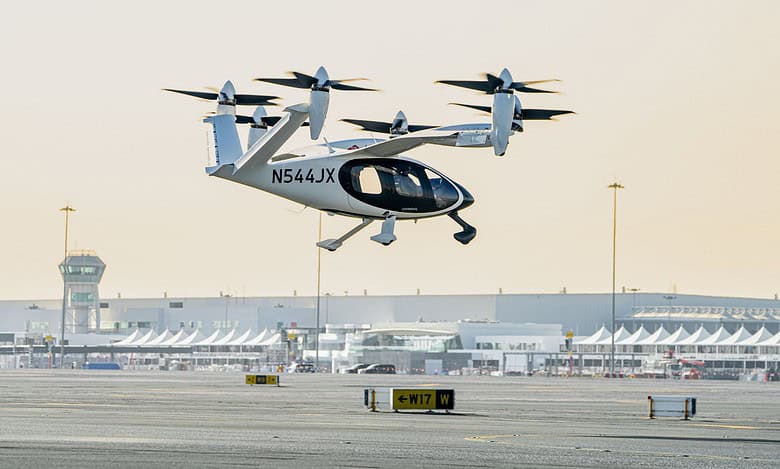 An electric vertical take-off and landing (eVTOL) air taxi operates during a test flight at Al Maktoum International Airport in Dubai.