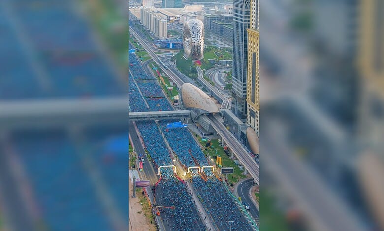 Aerial view of Dubai Run 2025 participants filling Sheikh Zayed Road near the Museum of the Future.