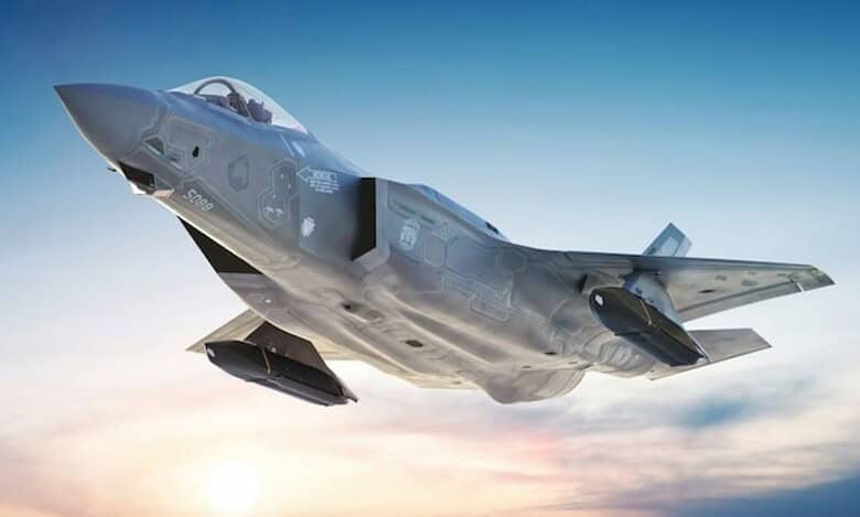 F-35 stealth fighter jet flying against a clear sky at sunrise.