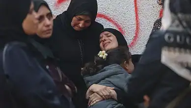 Mourners in Gaza grieve at al-Shifa Hospital after deadly overnight strikes.