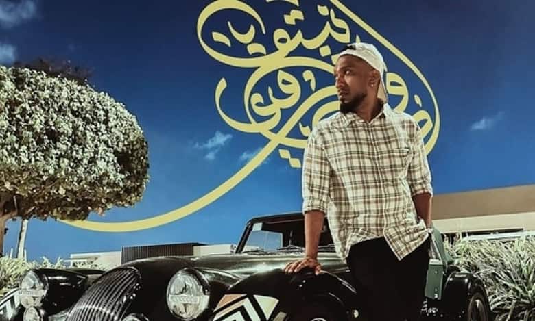 Advin Roy Netto standing beside a vintage car in Abu Dhabi.