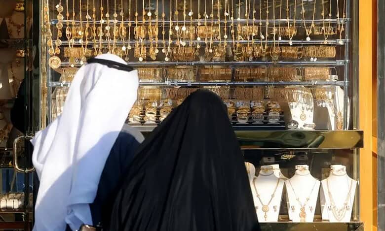Kuwaitis view gold jewellery displayed at a shop in Kuwait City.