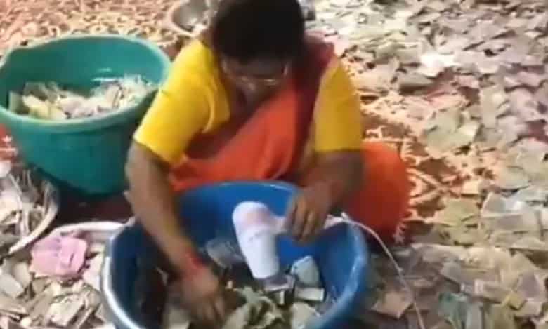 Devotee puts burning camphor in temple's donation box