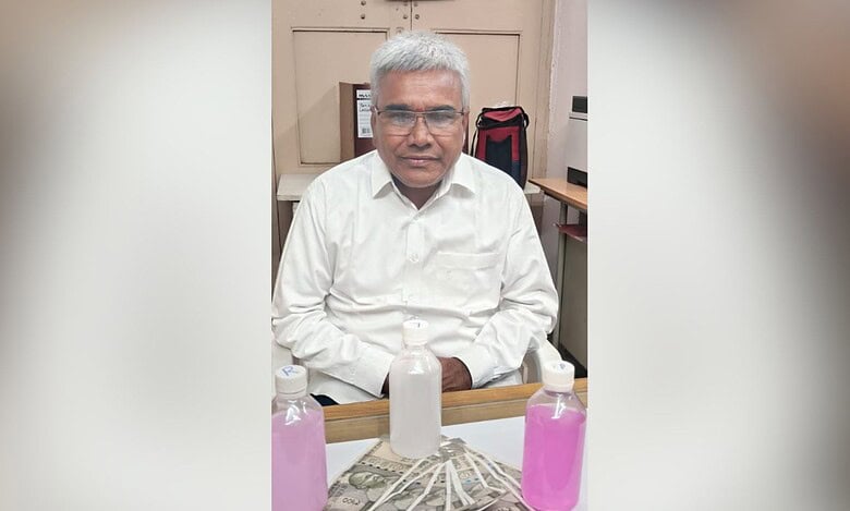 Image shows man in a white shirt with cash and bottles with pink fluid.