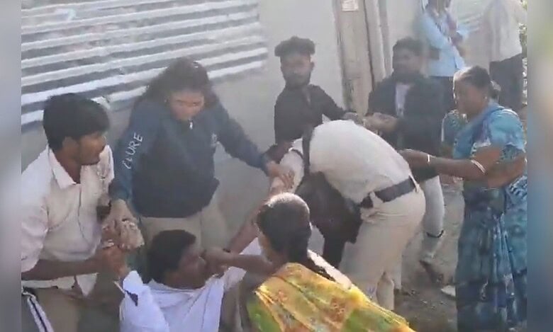Image shows a man hitting a police man with a rock in Telangana's Adilabad.