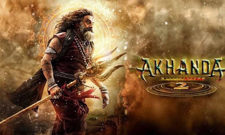 Movie poster for 'Akhanda 2' featuring a warrior with long hair and beard in traditional attire, holding a trident against a dramatic golden and dusty background with mystical circular symbols