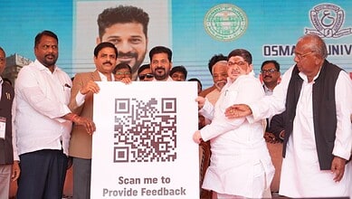 Government officials display a large QR code sign reading "Scan me to Provide Feedback" at a public event with Osmania University branding visible in the background.