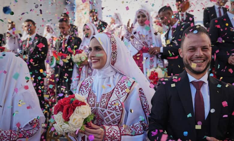 Palestinian couples participate in a mass wedding ceremony in Hamad City in Khan Younis, Gaza Strip