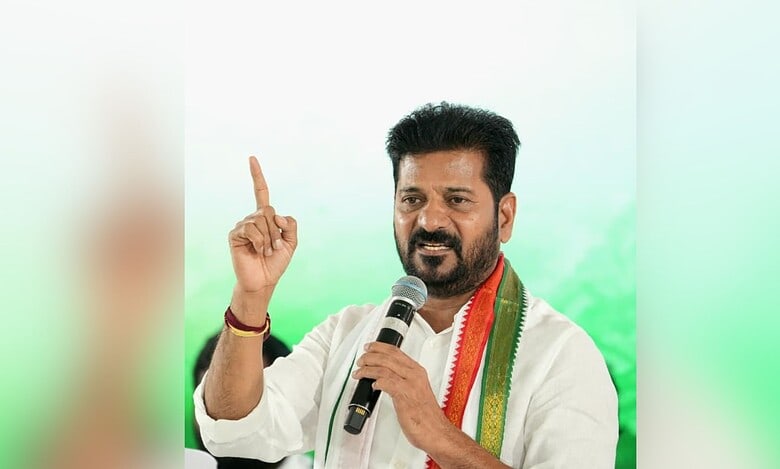 Image shows Telangana Chief Minister Revanth Reddy holding a mic