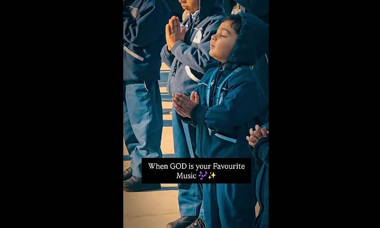 School boy dances during prayer