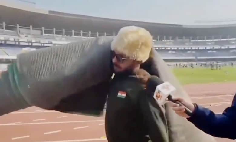 Man carries carpet from stadium after abrupt end to match featuring Messi
