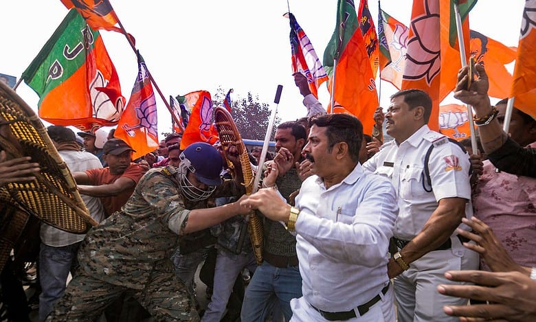 Security personnel try to stop BJP supporters during a protest against the alleged killing of a Hindu youth in Bangladesh, near Howrah Bridge, Wednesday, Dec. 24, 2025. (PTI Photo)
