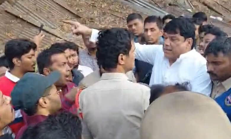 People argue with police during an encroachment drive in Afzalgunj