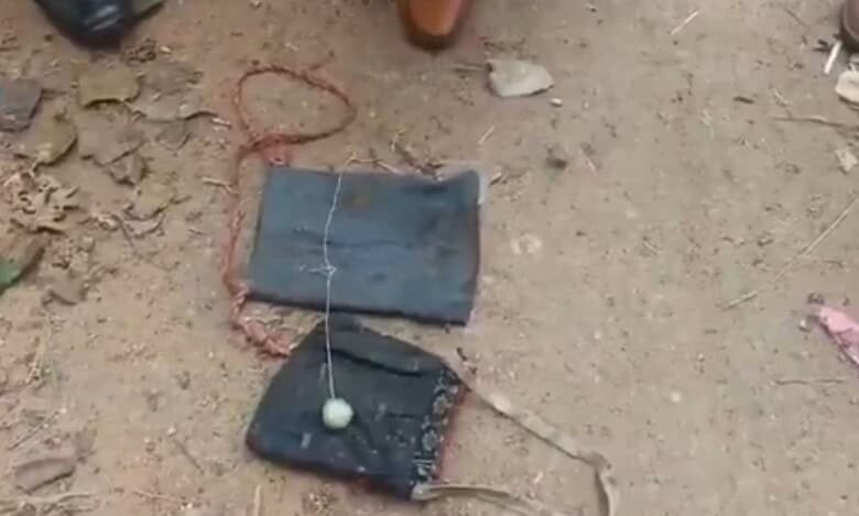 Image shows two cloth bags on the ground and a circular object on one of it