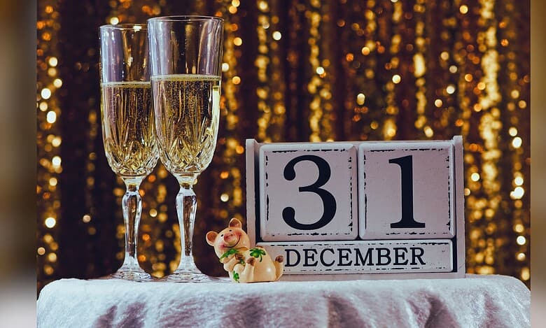 Image shows two champagne glasses alongside a calendar reading December 31