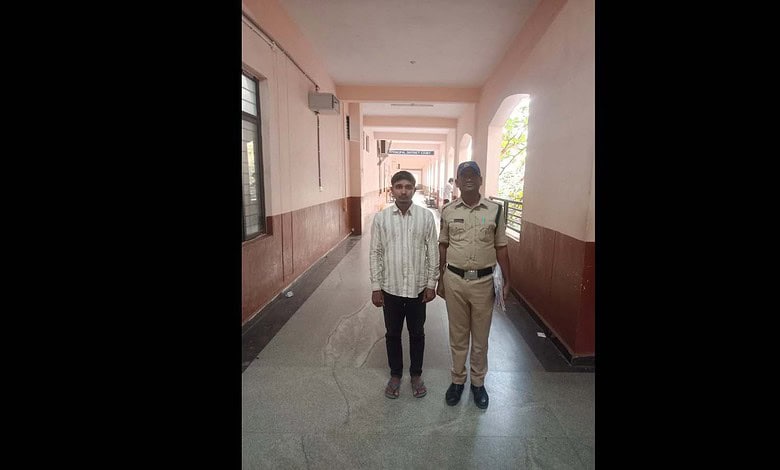 Convict Mohammed Siraj is seen with a police official
