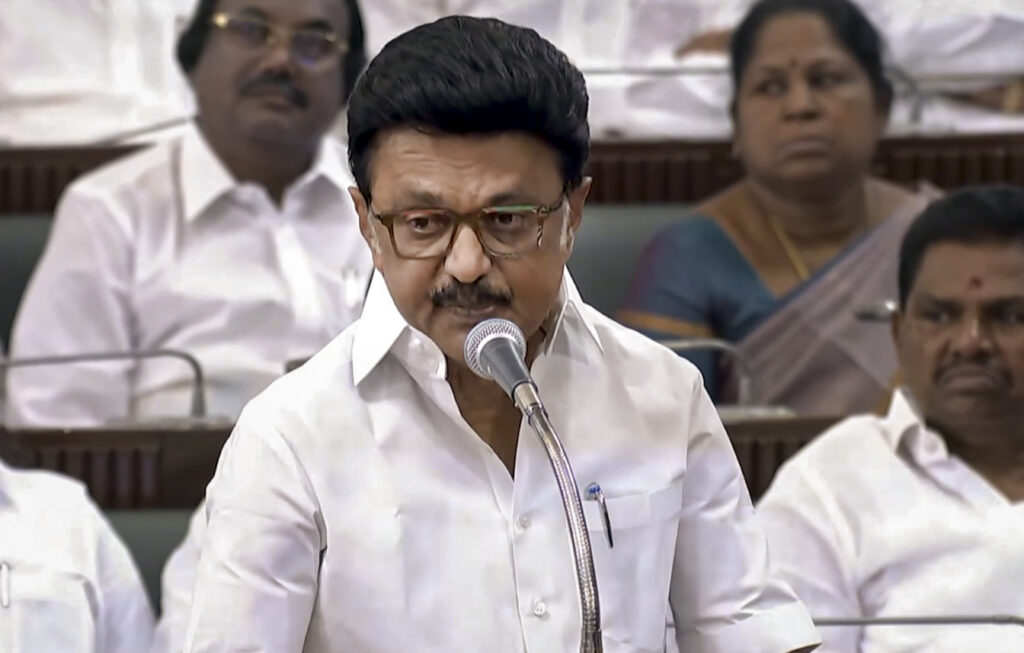 Indian politician addressing a meeting with colleagues and officials.